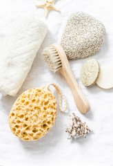 Wall Mural - shower accessories - face brush, sponge, pumice stone, towel, soap on a light background, top view. 