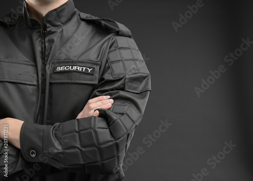 Cuadros en Lienzo Male security guard in uniform on dark background, closeup