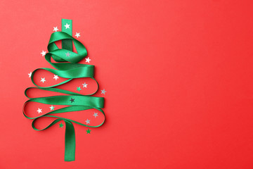 christmas tree made of green ribbon on color background, top view