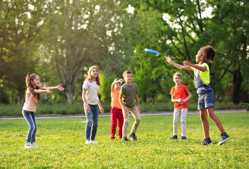 Poster - Cute little children playing with frisbee outdoors on sunny day