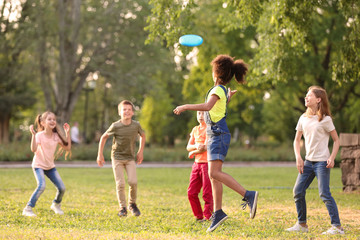 Poster - Cute little children playing with frisbee outdoors on sunny day