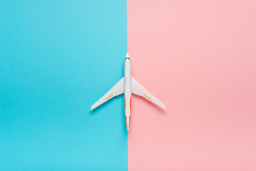 Wall Mural - Top view of an airplane on trendy color background.  Bright summer color. Travel concept.