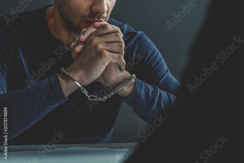 Fotomural Criminal man with handcuffs in interrogation room