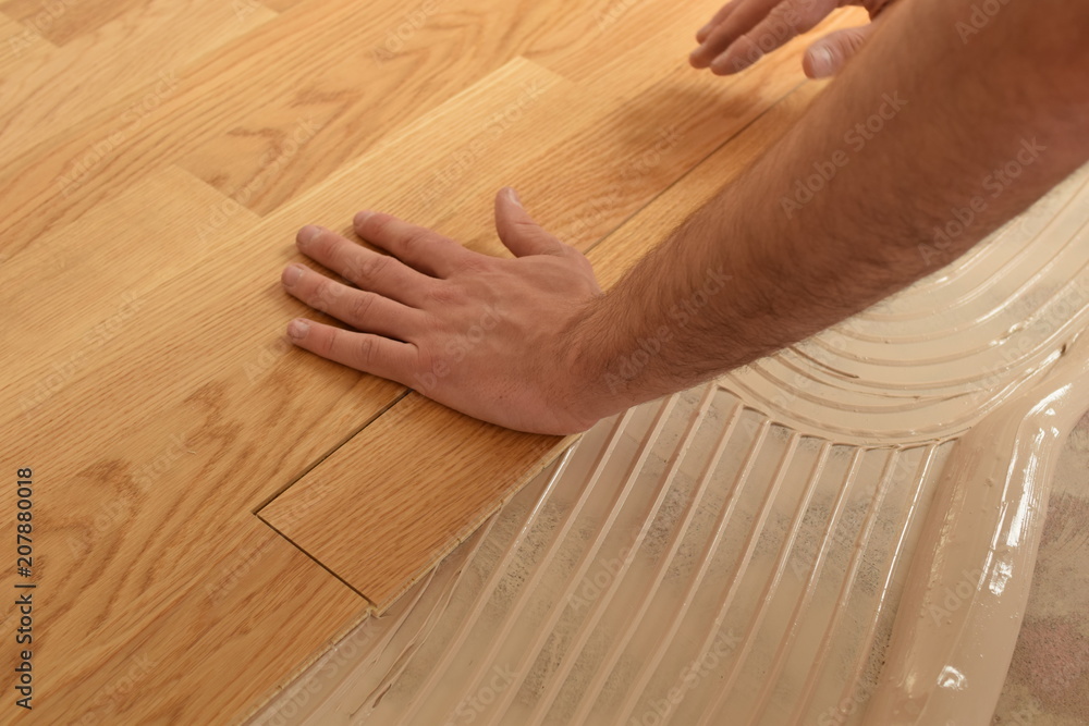 close up of worker installing wood parquet - obrazy, fototapety, plakaty 