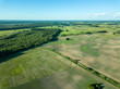 © Martins Vanags - drone image. aerial view of countryside road network, cultivated fields and forest textures