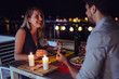 © NDABCREATIVITY - Young beautiful couple having romantic dinner on rooftop