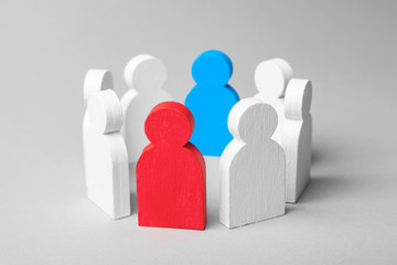 Wall Mural - Concept leader of a business team. Crowd of white men stands in circle and listens to leader of blue and red man, work with objections, conflict