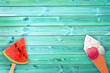 Watermelon popsicle and ice cream cone on blue planks background with copy space, summer concept