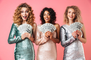 Canvas Print - Three beautiful excited women in shiny dresses