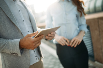 business people or businessman and businesswoman working outdoor