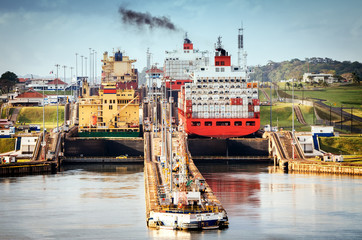 Panama City, Panama - February 20, 2015: A freighter entering the Canal locks of Miraflores in the Panama Canal, the Canal locks are at each end to lift ships up.