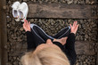 Top view of attractive senior blond woman, dressed in black, doing yoga poses outdoor on railroad. Siting in siddhasana. Concept: on the right path.