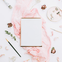 Wall Mural - Creative festive composition with photo frame mock up, pink blanket, flowers, eucalyptus branches and brushes on white background. Flat lay, top view stylish template.