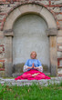 Portrait of beautiful mature woman practicing yoga and meditation,  with her palms together,  outdoor. Longevity concept 
