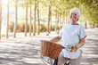 © Monkey Business - Portrait Of Smiling Senior Woman Cycling On Country Road