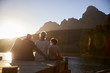 © Monkey Business - Grandchildren With Grandparents Sitting On Wooden Jetty By Lake