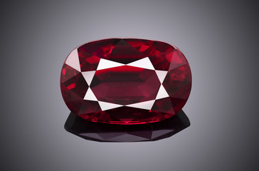 Wall Mural - Luxury red transparent sparkling gemstone  shape oval cut ruby isolated on grey background