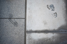 Footprints On Pavement