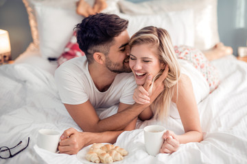 young couple having a breakfast in the bed