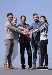 Canvas Print - group of young people clasped their hands together