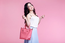 Beautiful Young Woman With Handbag On Pink Background