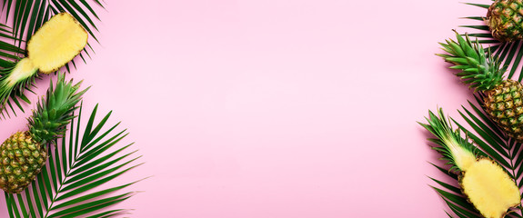 Wall Mural - pattern with bright pineapples, palm leaves on pink background. top view. copy space. minimal style.