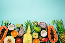 Exotic Fruits And Tropical Palm Leaves On Pastel Turquoise Background - Papaya, Mango, Pineapple, Banana, Carambola, Dragon Fruit, Kiwi, Lemon, Orange, Melon, Coconut, Lime. Top View.
