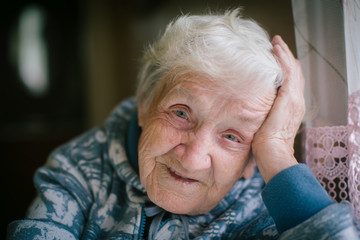 Portrait of a happy elderly woman close-up. Age 90 years old.