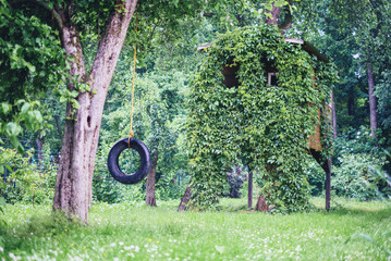 House on tree in green spring garden