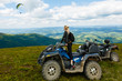 © Angelov - Happy woman riding a quad bike at the top of a mountain