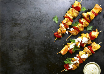 Wall Mural - Chicken skewer kebab with bell pepper and yogurt sauce.Top view with copy space.