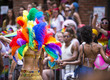 Participant dressed in flamboyant carnival costume participates in annual Pride Parade as it passes through Greenwich Village.