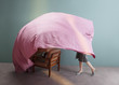© Ulas and Merve/Stocksy - woman playing with pink sheet