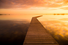 Beautiful Sunrise On A Lake With A Wooden Dock