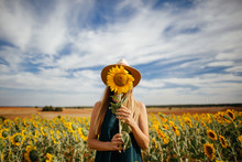 Caucasian Woman Enjoying Summer Time At Sunflowers Field