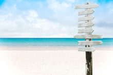 Blank Wooden Sign On A Sand Beach And Beautiful Sea Background In Summer.