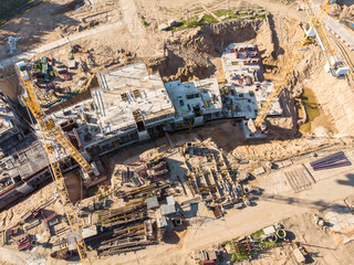 two cranes working on big construction site. aerial view