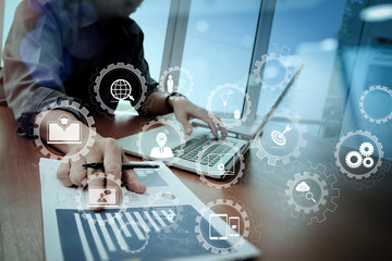 Poster - business documents on office table with smart phone and digital tablet and graph business diagram and man working in the background