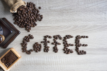  top view Coffee beans on wooden background in form of word of 
