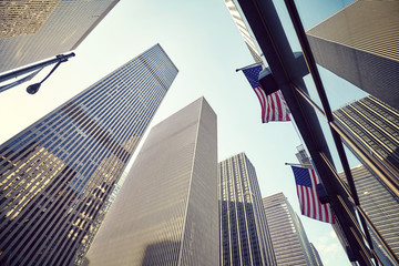 Looking up at New York skyscrapers at sunset, color toned picture, USA.