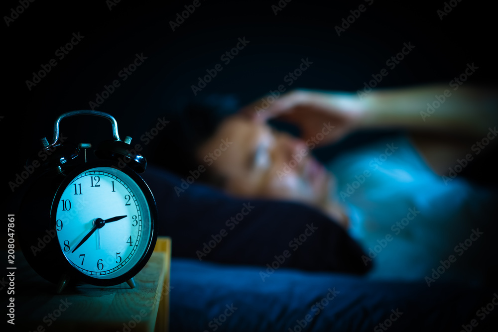 asian man in bed suffering insomnia and sleep disorder thinking about ...