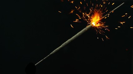 Wall Mural - bengal lights. one stick of bengal fire located on a diagonal of a frame, lights up an orange glow. 