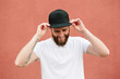 © 4Max - Hipster handsome male model with beard wearing white blank t-shirt and a baseball cap with space for your logo or design in casual urban style