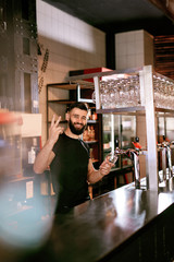 Wall Mural - Bartender Working At Bar Pub Pouring Beer In Glass