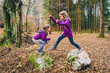 © _jure - Identical twins are jumping from rocks in forest on hiking.