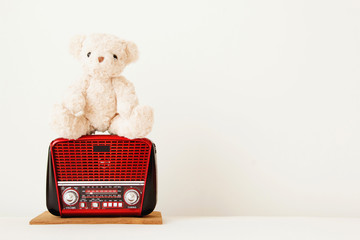 Cute teddy bear is listening song from red radio that retro style .Relax and happy feel.