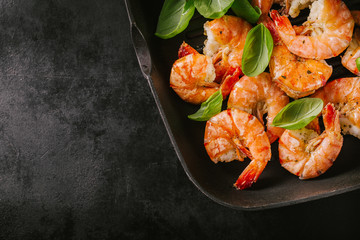 Wall Mural - Grilled king prawns on pan on dark table