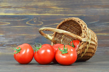 Tomatoes In The Basket On Wooden Background