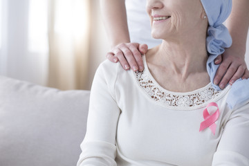 Wall Mural - Senior woman with pink ribbon