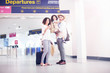 © Connect Images - Family standing together at departure lounge of airport